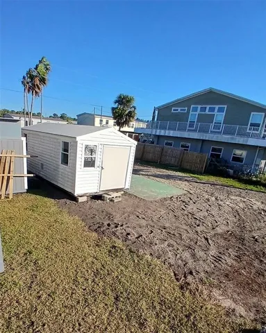 a view of a house with backyard and sitting area