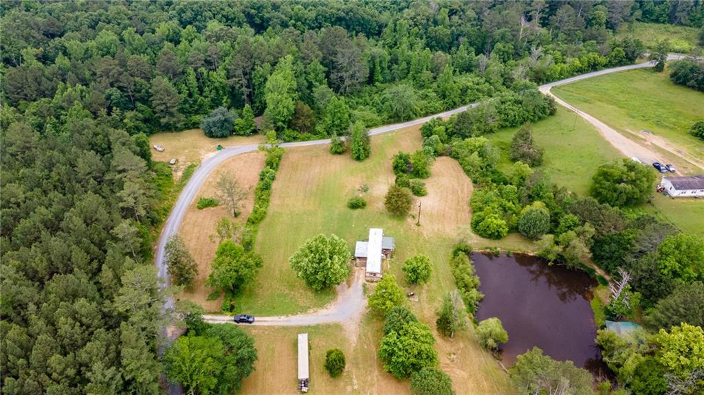 6932 Nicklesville Road Northeast Ranger, GA 30734 - Photo 1 of 1 an aerial view of a house with a yard and trees