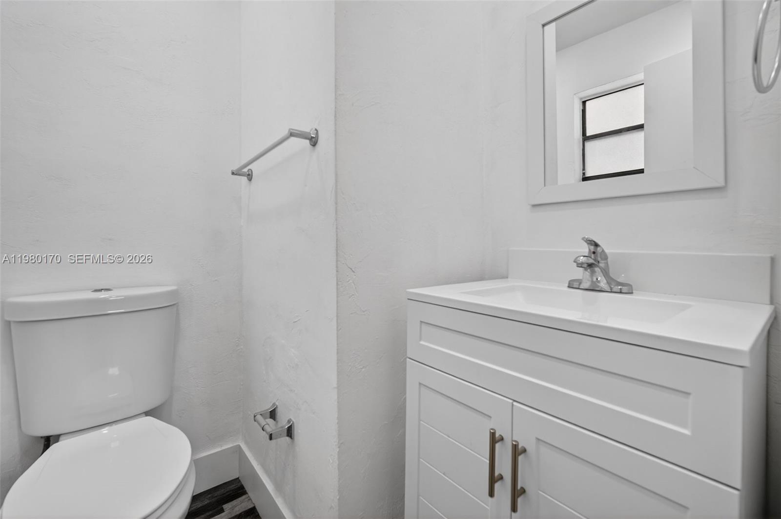 3265 Virginia Street, Unit 25 Miami, FL 33133 - Photo 1 of 28 a bathroom with a toilet sink and mirror