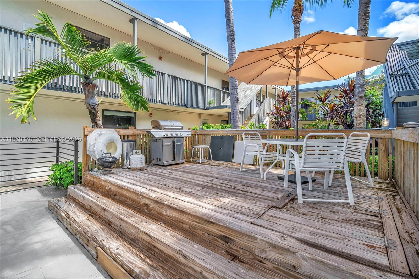 3265 Virginia Street, Unit 25 Miami, FL 33133 - Photo 15 of 28 a view of a patio with table and chairs under an umbrella