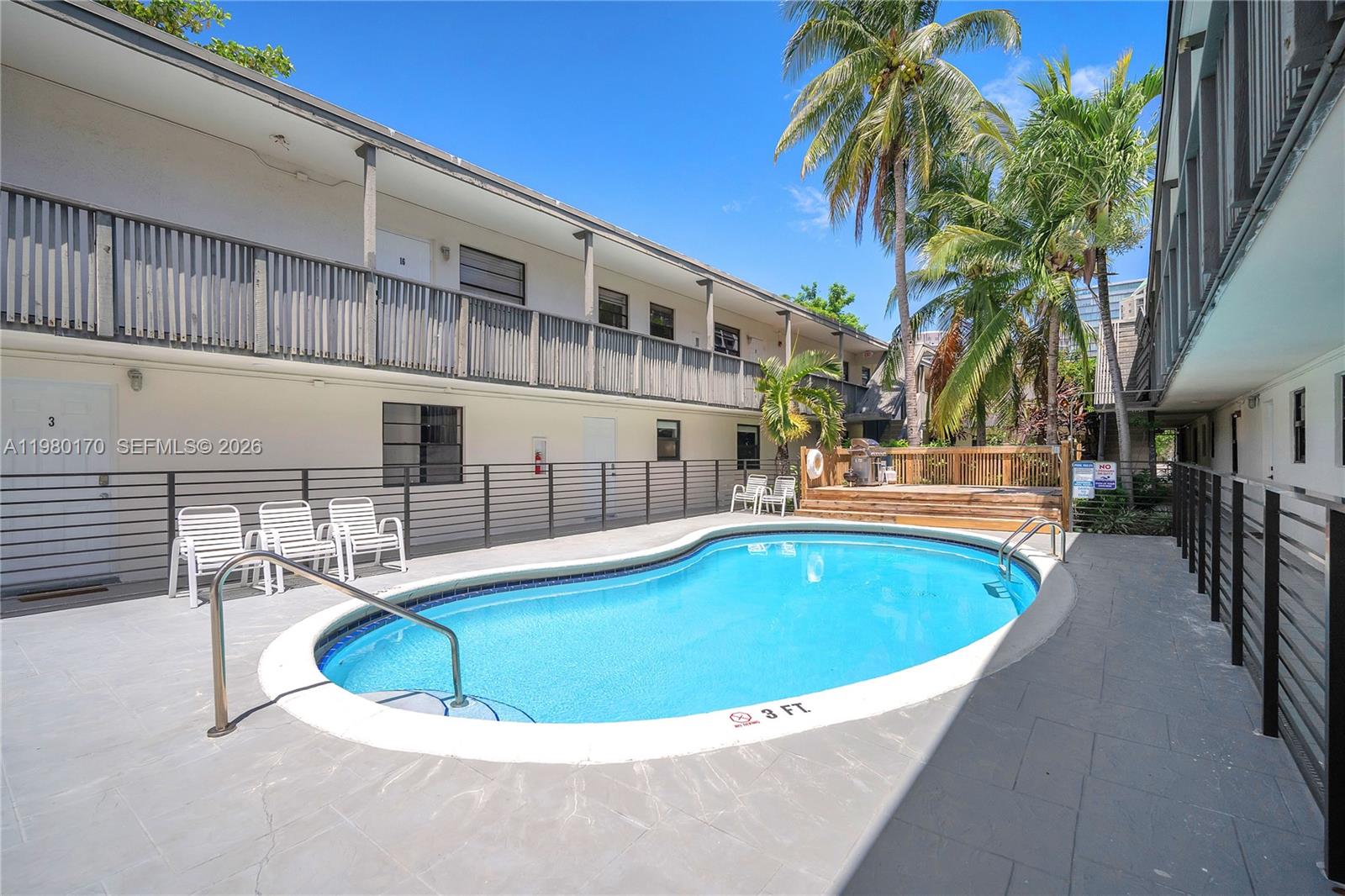 3265 Virginia Street, Unit 25 Miami, FL 33133 - Photo 28 of 28 a view of a swimming pool with a patio