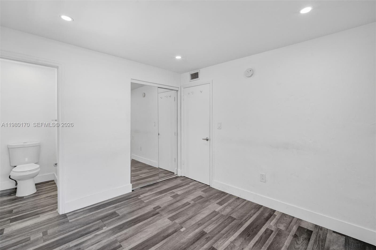 3265 Virginia Street, Unit 25 Miami, FL 33133 - Photo 3 of 28 a bathroom with a sink and a toilet