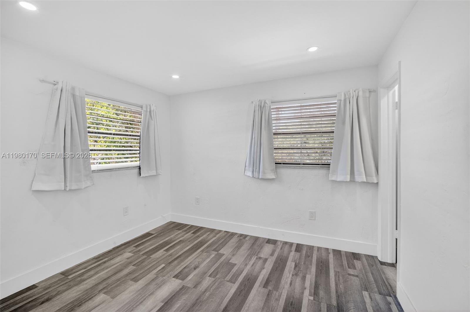 3265 Virginia Street, Unit 25 Miami, FL 33133 - Photo 4 of 28 wooden floor in an empty room with a window