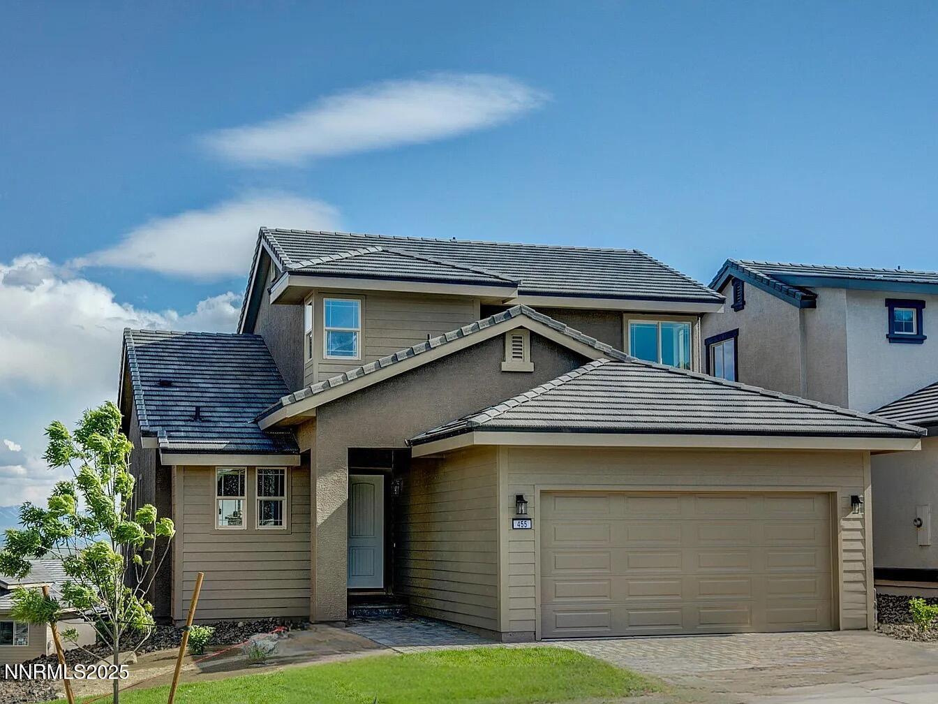 a front view of a house with a garage