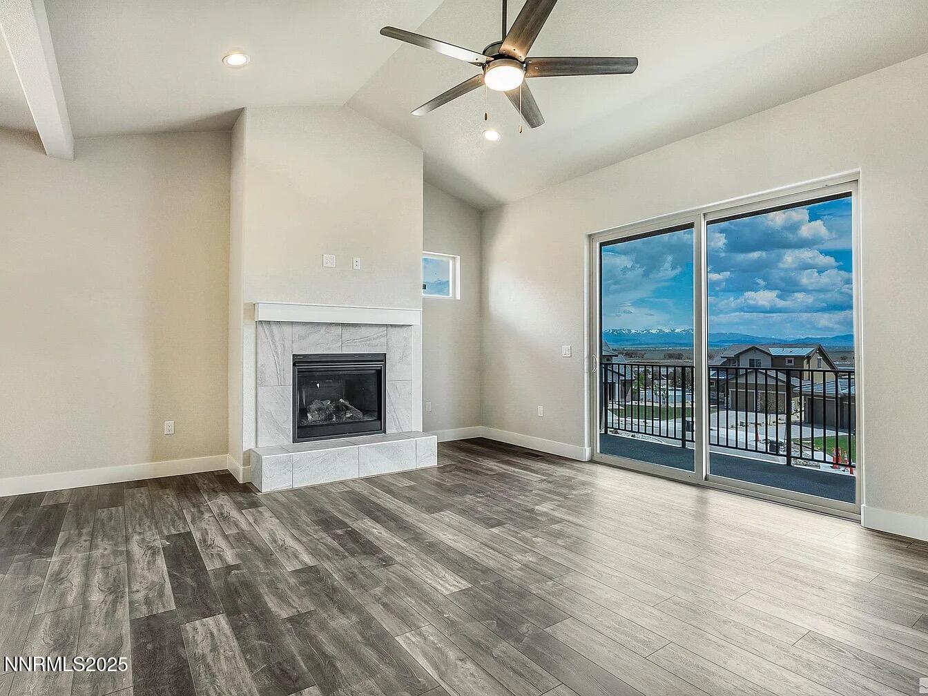 455 Axelson Way Genoa, NV 89411 - Photo 15 of 30 a view of an empty room with a fireplace and a window