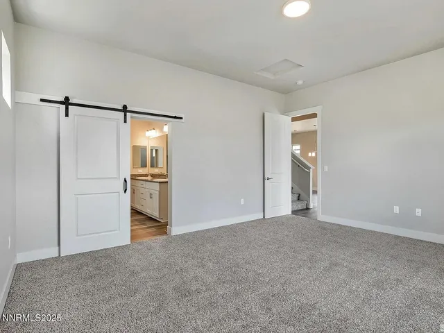 a view of a kitchen with a refrigerator and a stove top oven