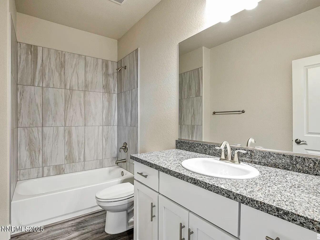 455 Axelson Way Genoa, NV 89411 - Photo 23 of 30 a bathroom with a granite countertop sink toilet and shower
