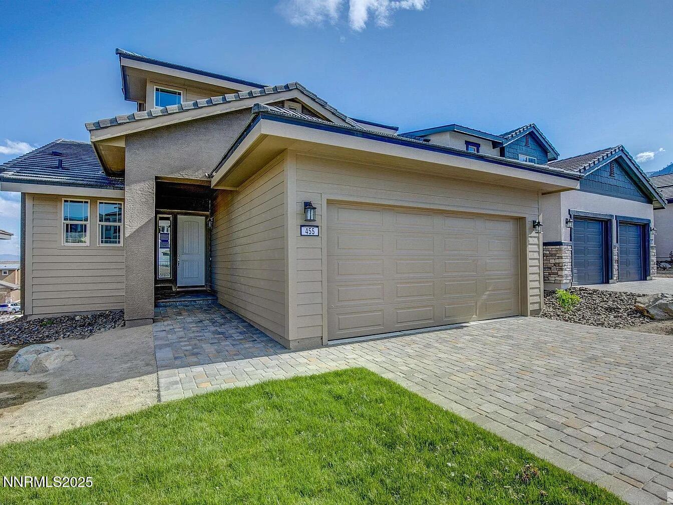 455 Axelson Way Genoa, NV 89411 - Photo 4 of 30 a front view of a house with a garage
