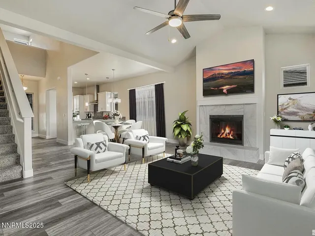 a living room with furniture a flat screen tv and a fireplace
