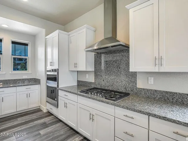 a kitchen with granite countertop white cabinets and white appliances