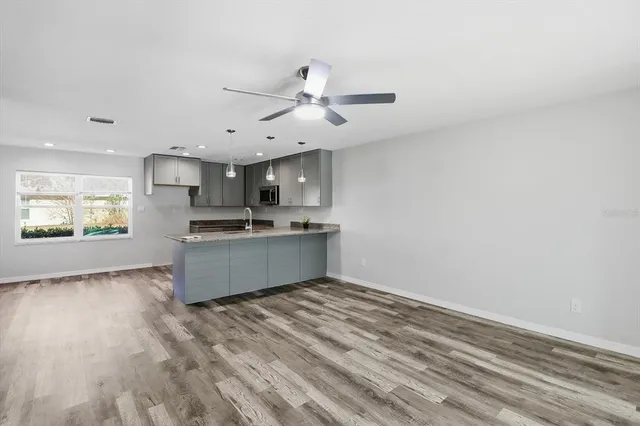 a large kitchen with kitchen island a sink stainless steel appliances and cabinets