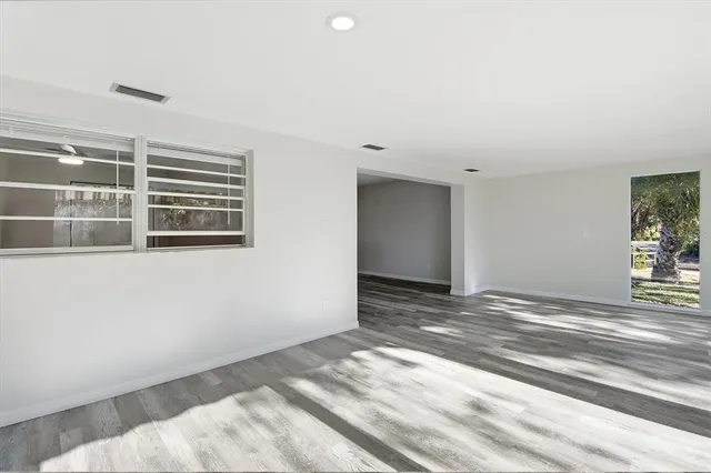 a view of a livingroom with wooden floor and a window