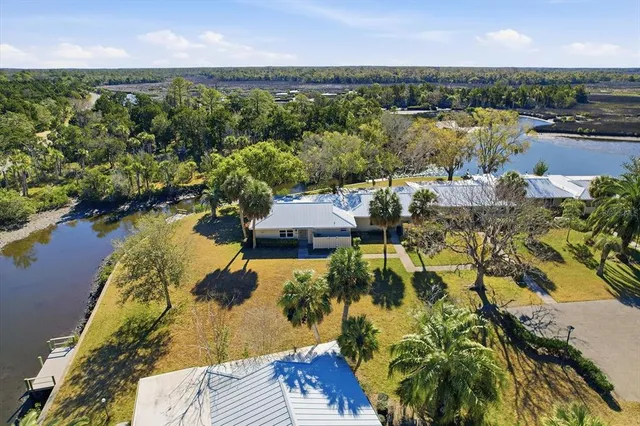 an aerial view of residential houses with outdoor space and lake view