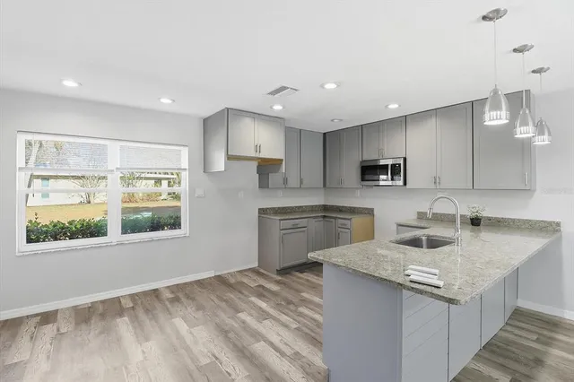 a kitchen with a sink stove top oven and refrigerator