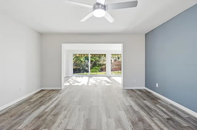 wooden floor in an empty room with a window