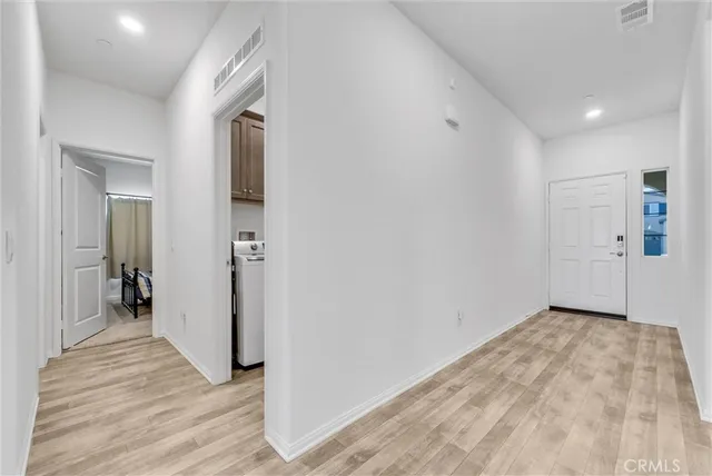 a view of hallway with wooden floor
