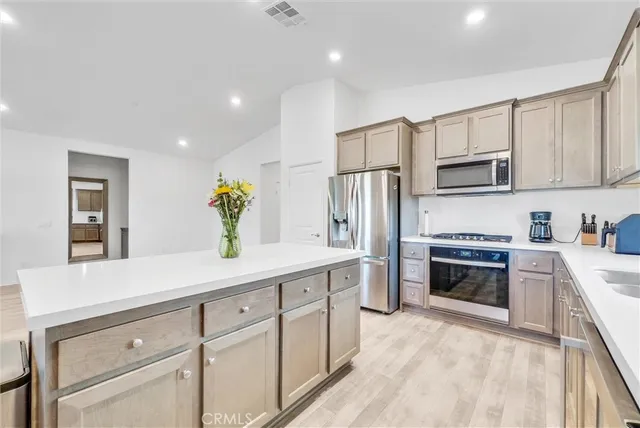 a kitchen with stainless steel appliances a stove cabinets and a refrigerator