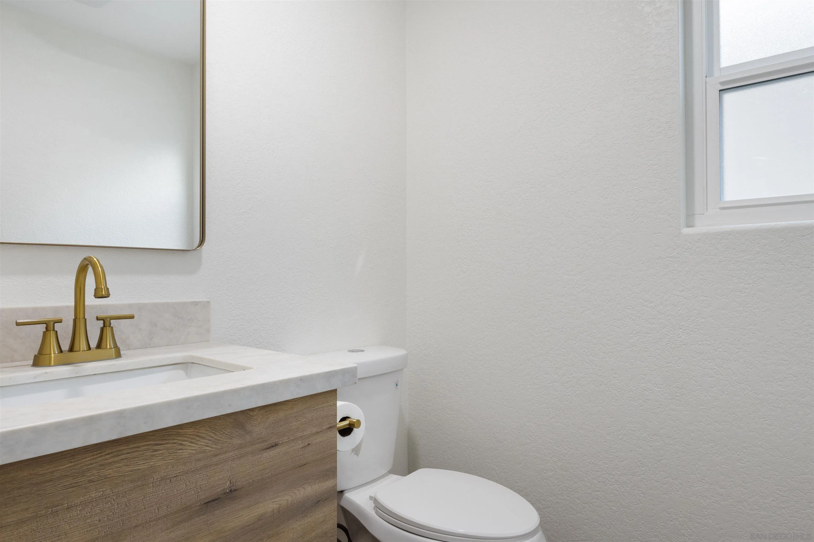 4350 Point Reyes Court Carlsbad, CA 92010 - Photo 17 of 33 a bathroom with a sink toilet and mirror