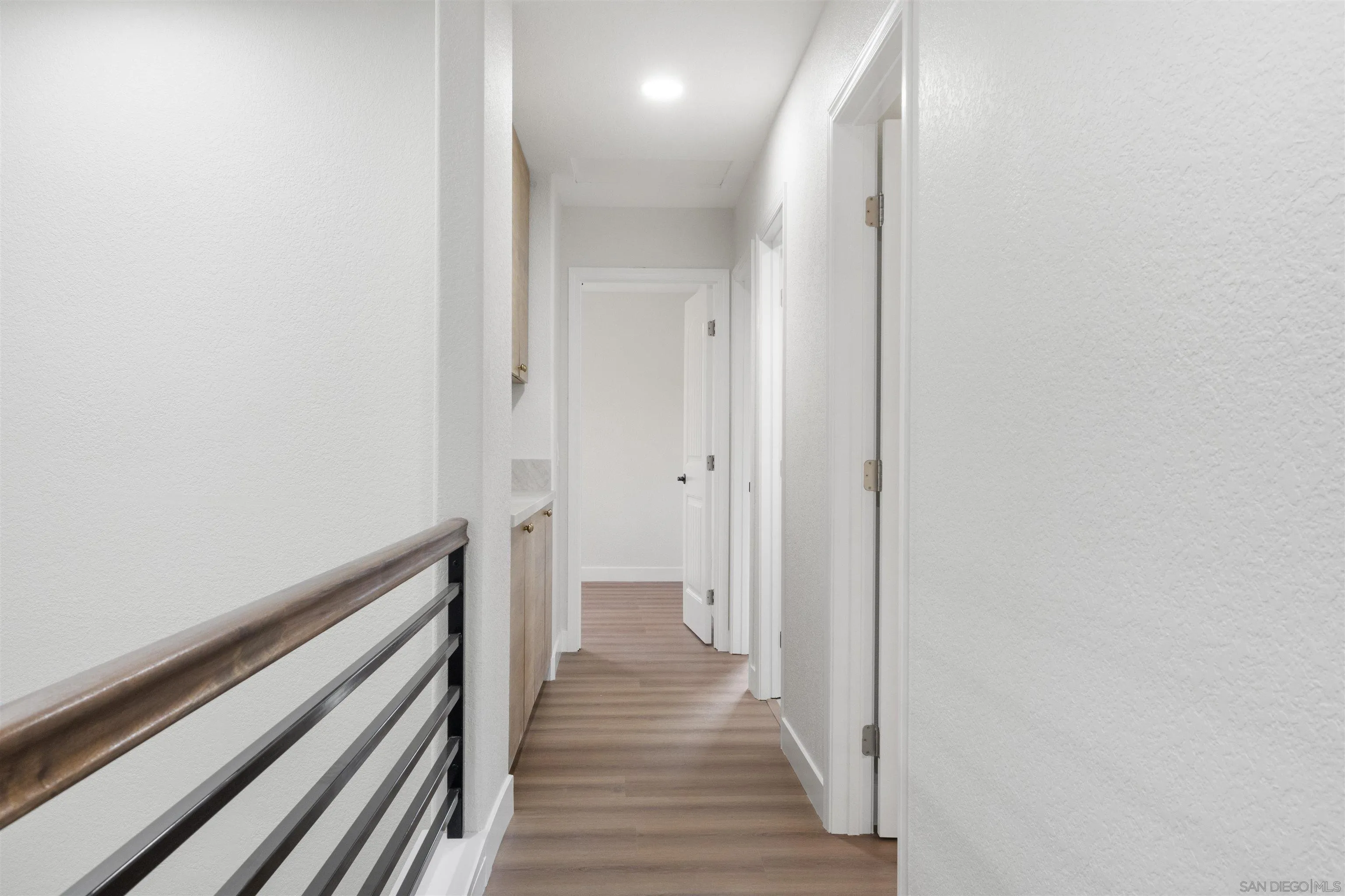 4350 Point Reyes Court Carlsbad, CA 92010 - Photo 24 of 33 a view of a hallway with wooden floor and a bathroom
