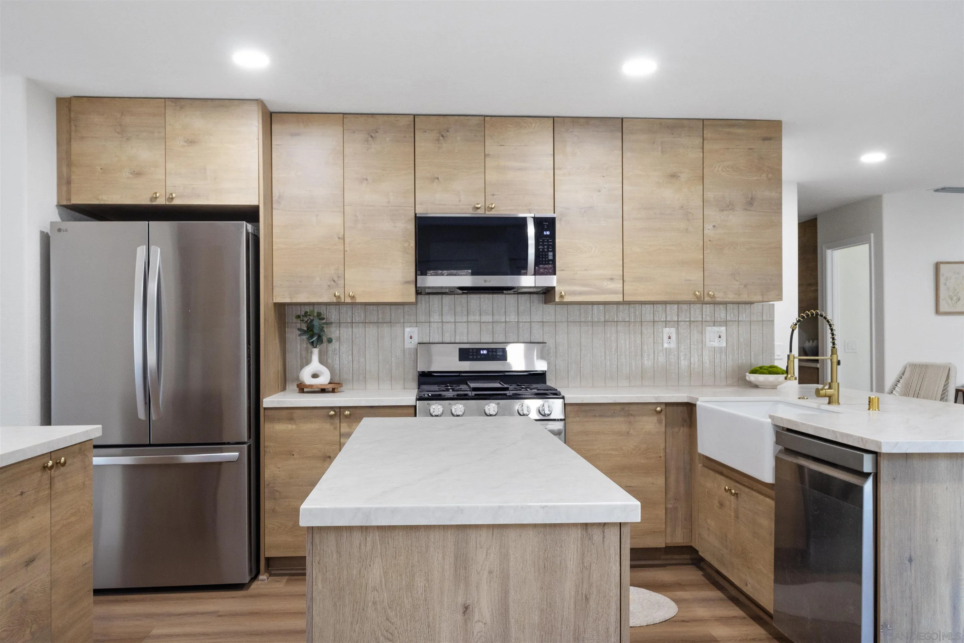 4350 Point Reyes Court Carlsbad, CA 92010 - Photo 4 of 33 a kitchen with a refrigerator sink and microwave