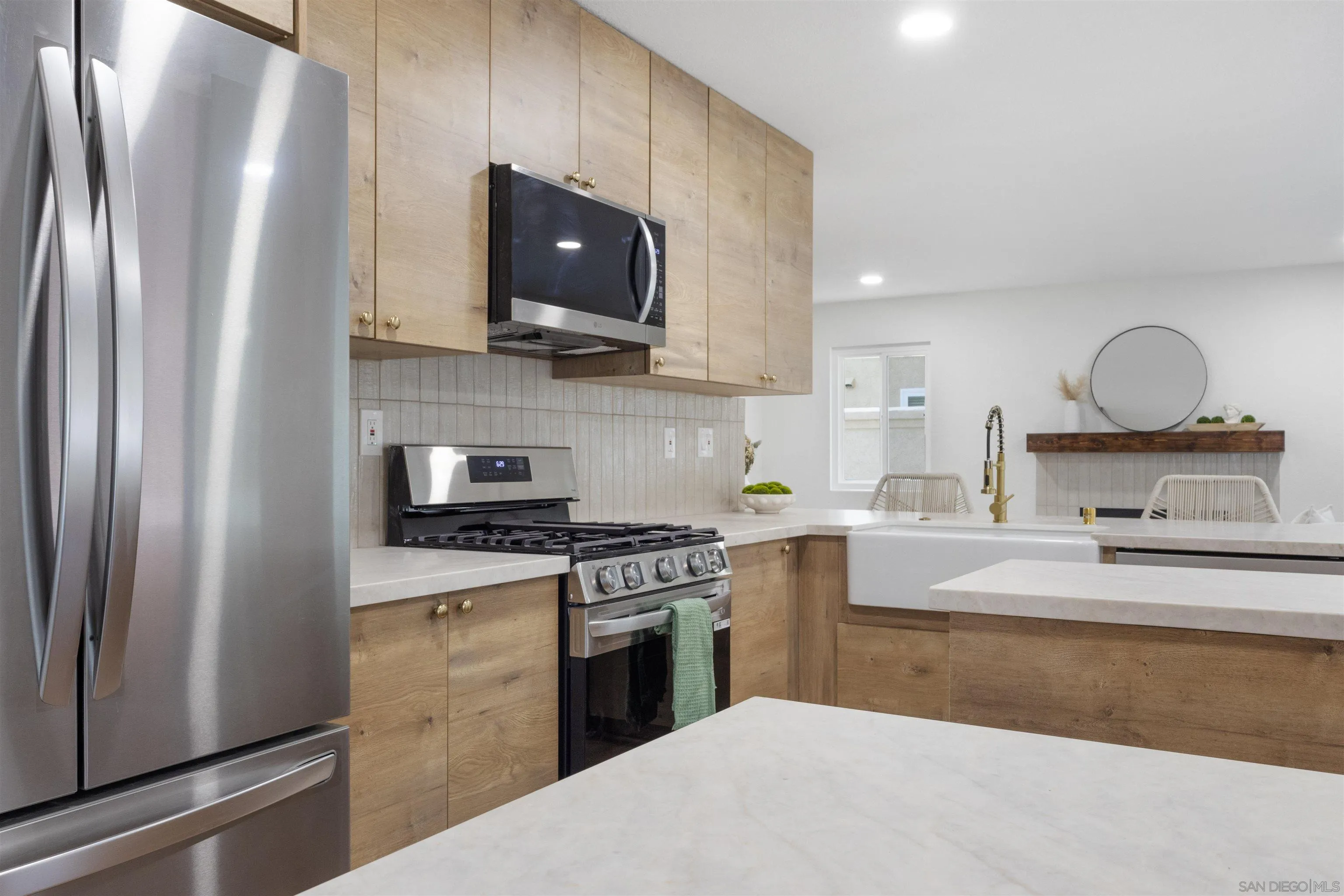 4350 Point Reyes Court Carlsbad, CA 92010 - Photo 6 of 33 a kitchen with stainless steel appliances granite countertop a stove a sink and a refrigerator