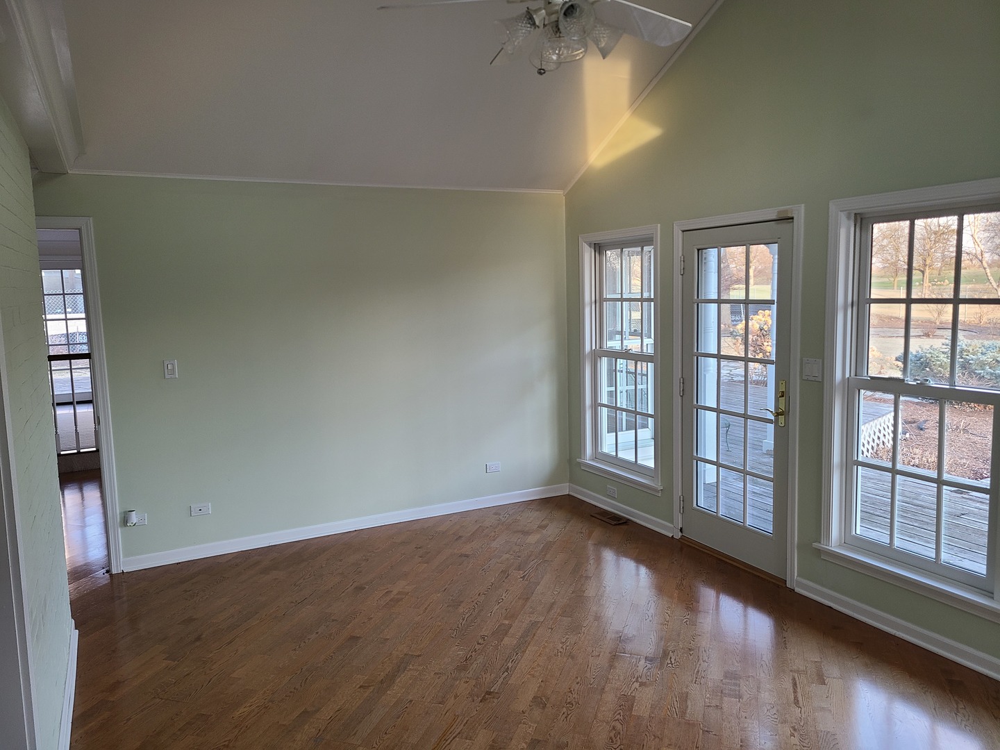 630 Greenview Road Itasca, IL 60143 - Photo 5 of 12 an empty room with wooden floor and windows with curtains