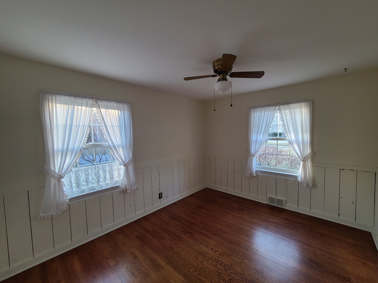630 Greenview Road Itasca, IL 60143 - Photo 6 of 12 a view of an empty room with wooden floor and a window