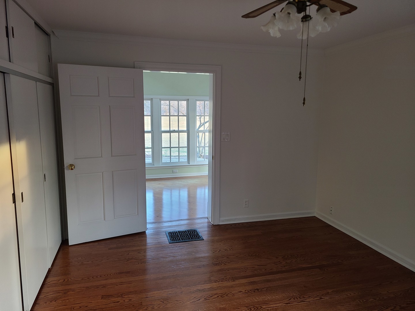 630 Greenview Road Itasca, IL 60143 - Photo 7 of 12 a view of an empty room with wooden floor and a window