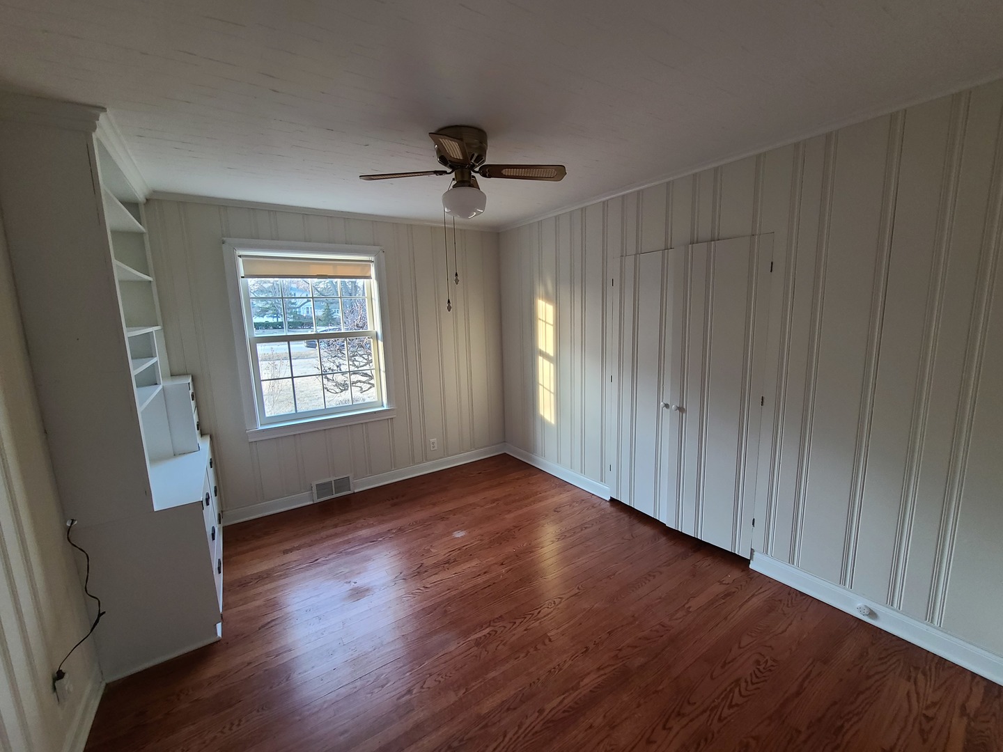 630 Greenview Road Itasca, IL 60143 - Photo 8 of 12 a view of an empty room with wooden floor and a window