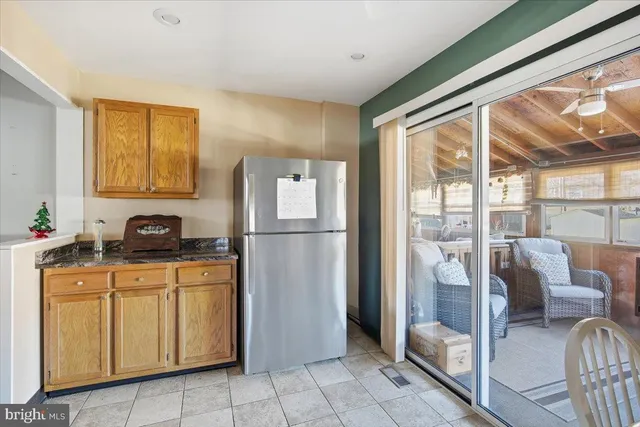 a kitchen with stainless steel appliances granite countertop a refrigerator and a sink