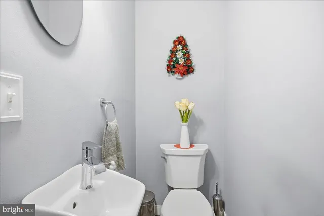 a white toilet sitting next to a bathroom sink