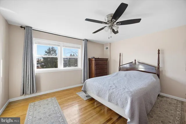 a bedroom with a large bed and a window