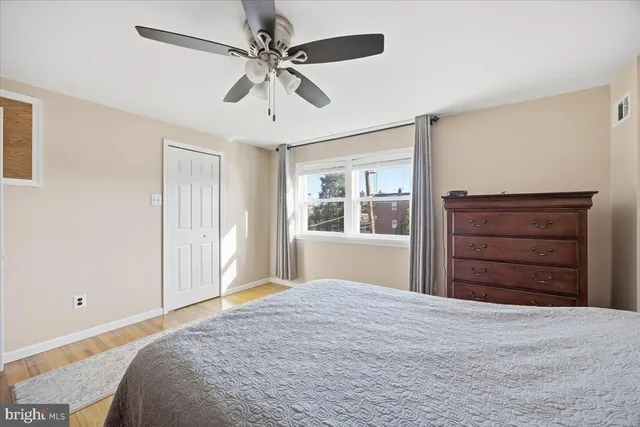 a bedroom with a bed dresser and a window
