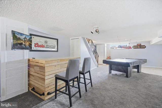 a bedroom with furniture and a rug