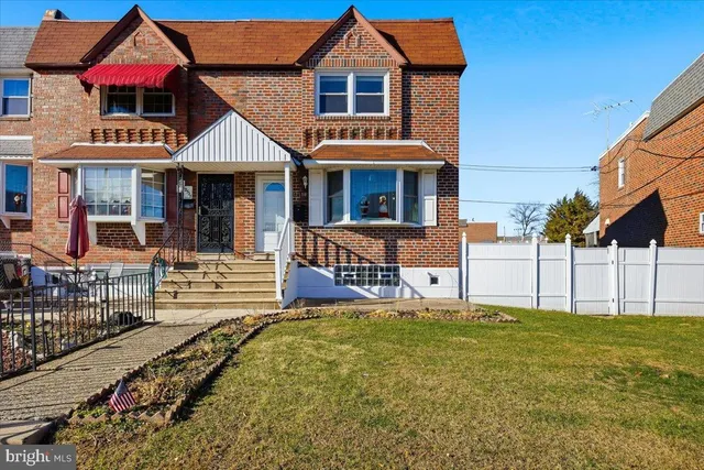 a front view of a house with a yard table and chairs