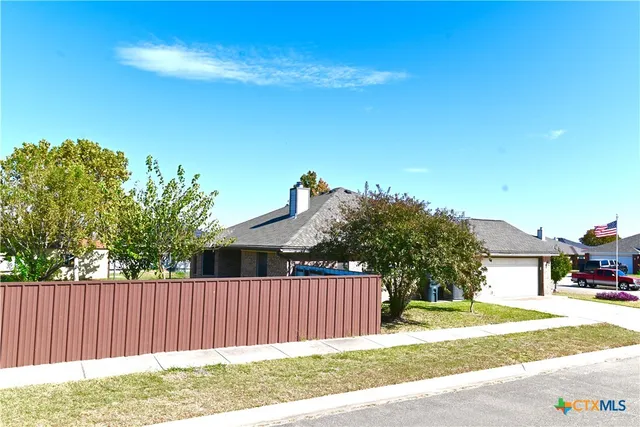 a view of a backyard with a tree