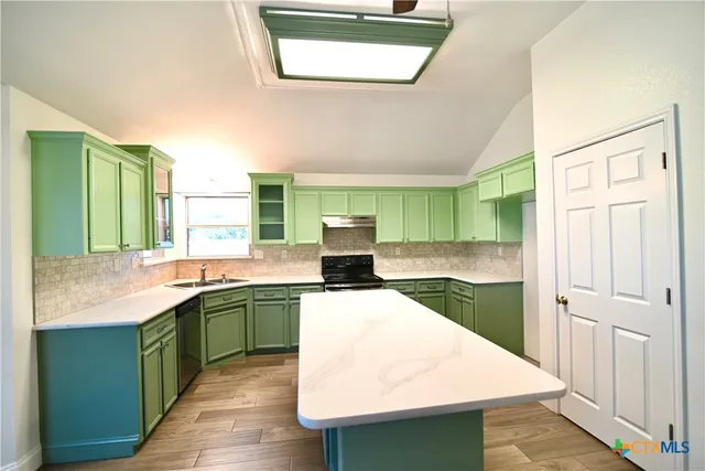 a kitchen with a sink stove and cabinets