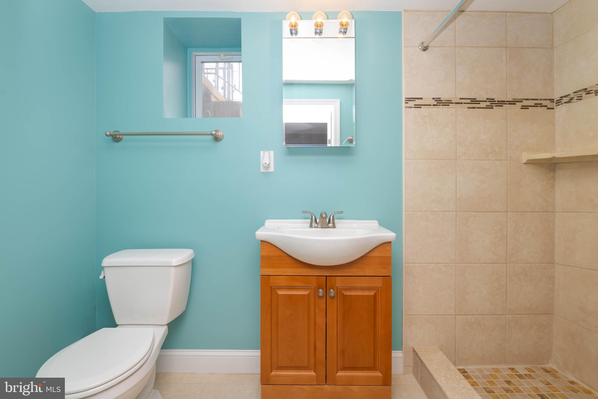 409 Regester Avenue Baltimore, MD 21212 - Photo 38 of 44 a bathroom with a toilet sink and mirror