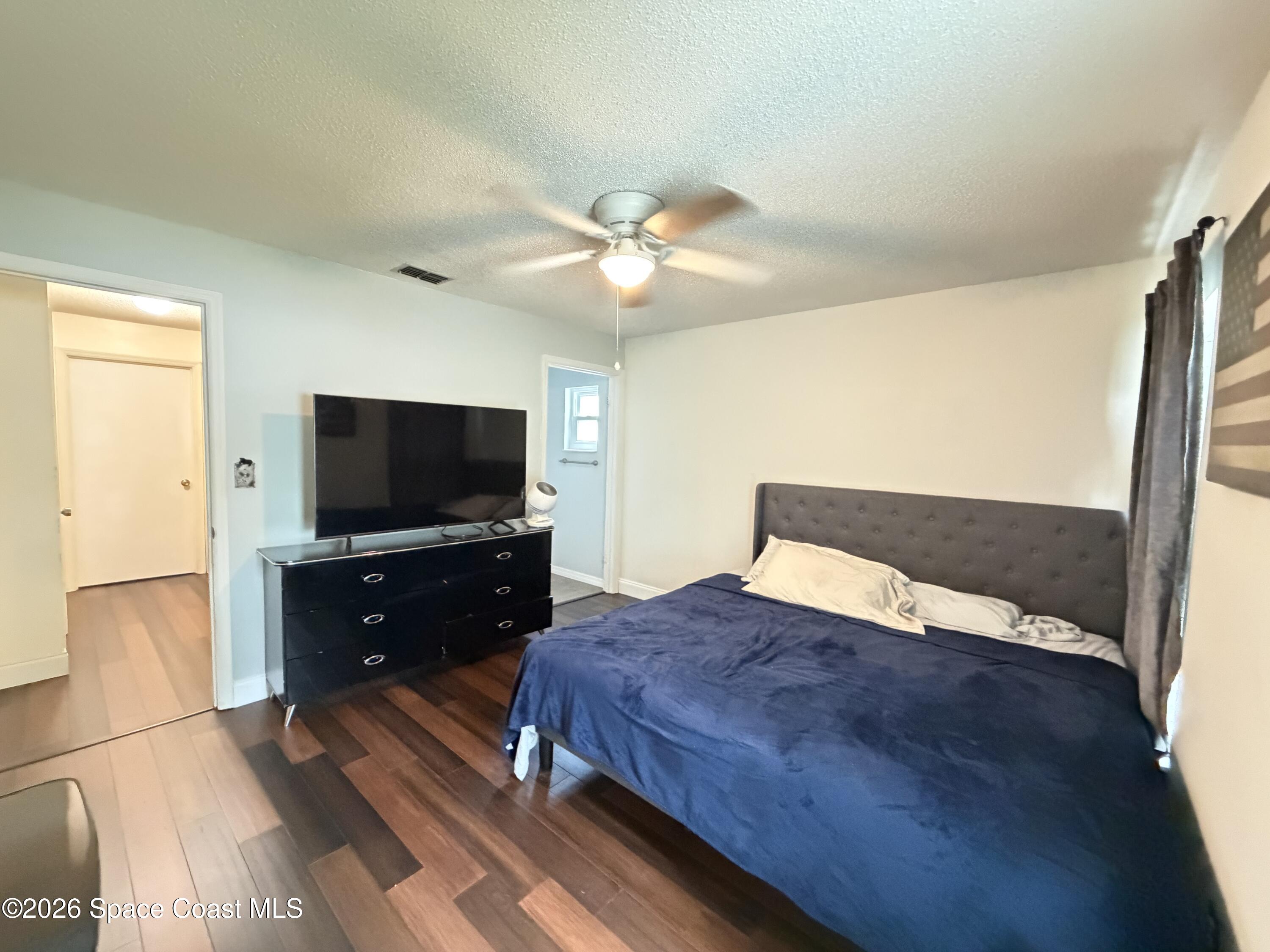 1578 West Powder Horn Road Titusville, FL 32796 - Photo 10 of 22 a bedroom with a bed and a flat screen tv