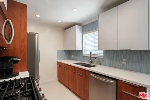a kitchen that has a sink and a stove