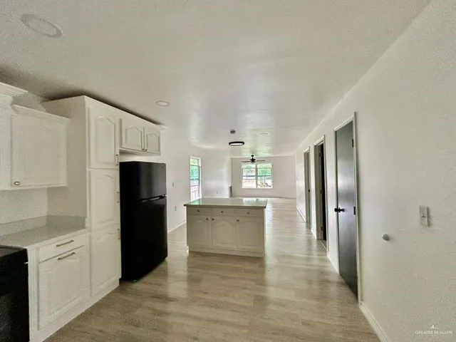 a large kitchen with cabinets and stainless steel appliances