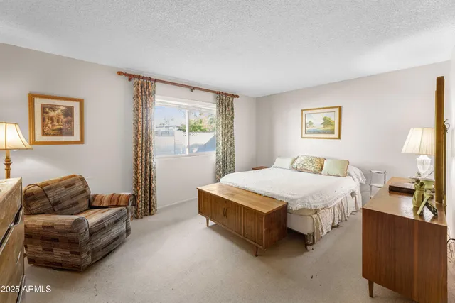 a spacious bedroom with a bed and a couch