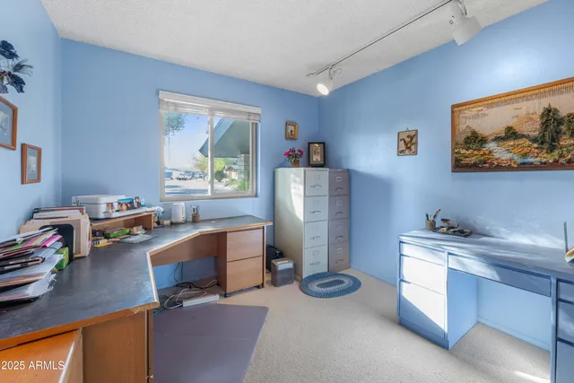 a room with furniture a window and a flat screen tv