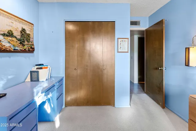 a view of a hallway to rooms and wooden floor
