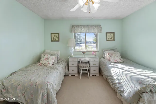 a bedroom with a bed and a table chair