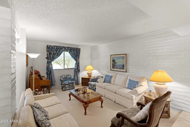 a living room with furniture a rug and a window