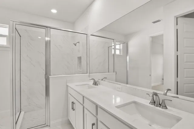 a bathroom with double vanity sink and a mirror