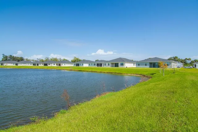a view of a lake with houses in the back
