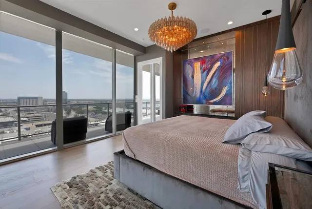 a bedroom with a large bed and a chandelier
