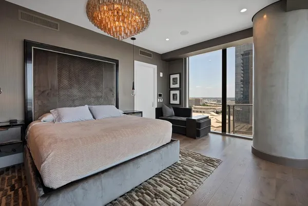 a bedroom with a bed and a large window